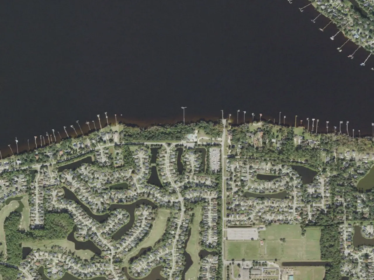 Aerial view of Eagle Harbor homes, lakes, and waterfront on Fleming Island